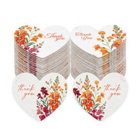 Bulk pack of heart-shaped floral thank you tags with watercolor snapdragon designs, showing multiple stacks and example cards