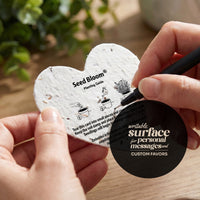 Detail photo of seed paper tag back side showing planting instructions and SeedBloom branding, with writable surface feature badge highlighted