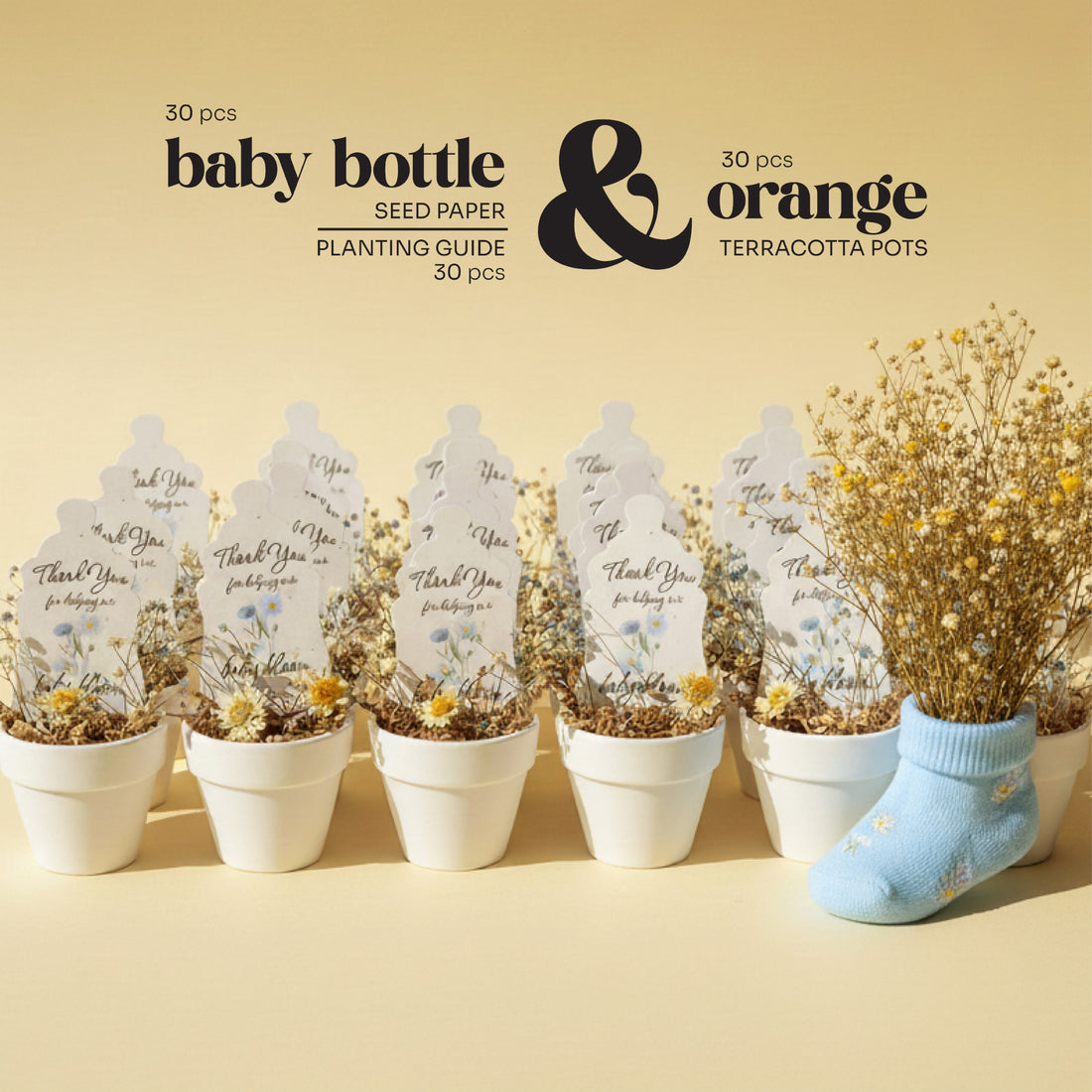 Baby bottle seed paper by Seed Bloom Gifts and terracotta pots with plants on a beige background