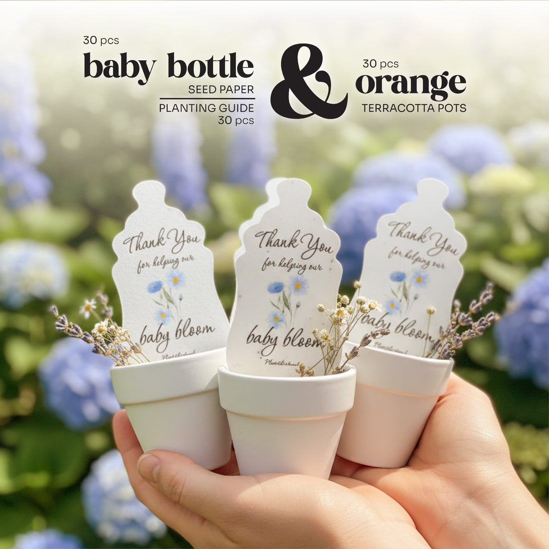 30pcs Seed paper baby bottle shapes by Seed Bloom Gifts in terracotta pots with a hand holding them, set against a blurred floral background.
