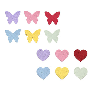 A set of small butterfly and heart-shaped pieces in pastel and bright colors, including purple, pink, red, light blue, yellow, and pale green, arranged on a plain white background.