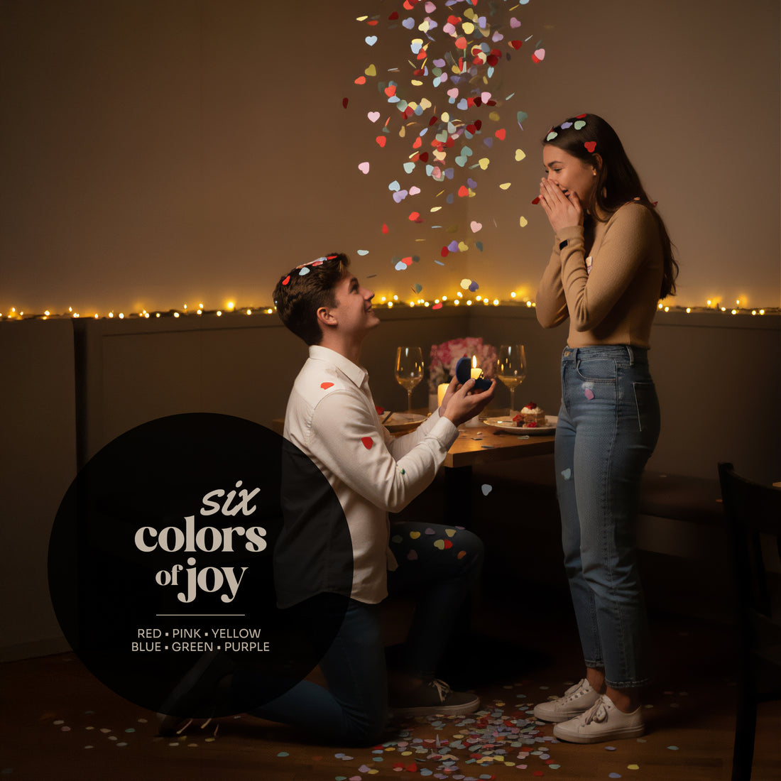 Man proposing to a woman with colorful heart-shaped confetti in an urban setting.