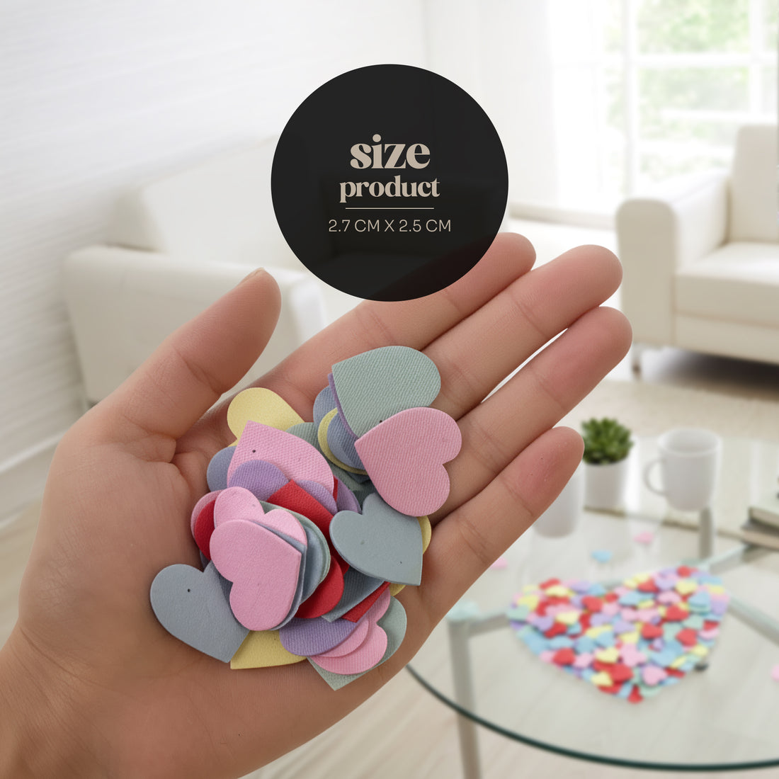 Hand holding colorful heart-shaped confetti with a size label in a bright room.