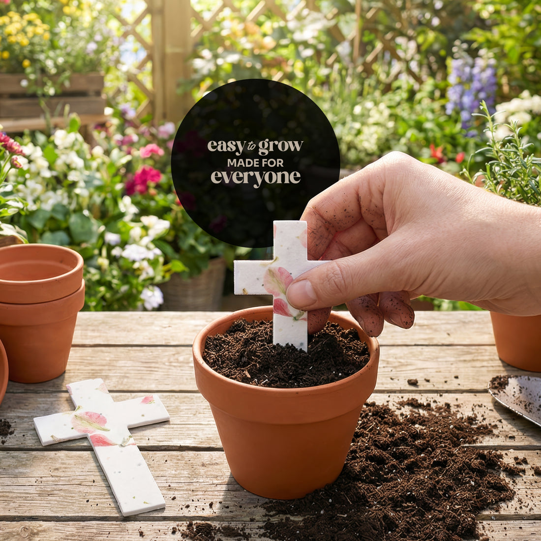 Bloom plantable seed paper cross funeral favor being planted in terra cotta pot with soil in garden, easy to grow for everyone