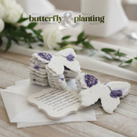 Butterfly-shaped seed paper on a wooden surface with white flowers in the background.