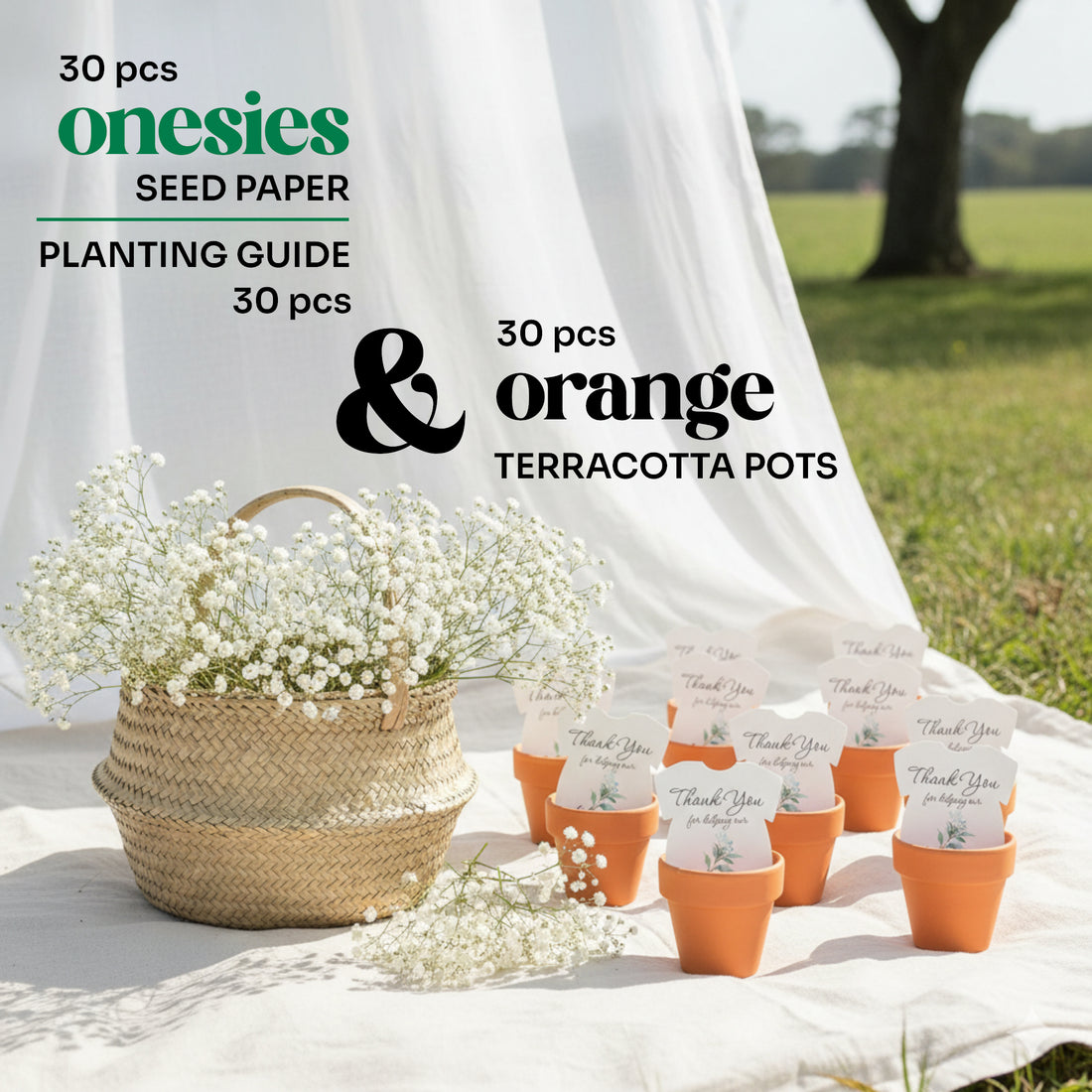 Outdoor baby shower display featuring 30 plantable seed paper onesie favors arranged in orange terracotta pots on a white cloth, accompanied by a basket of white flowers and labeled as including a planting guide.