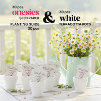 Set of 30 plantable seed paper onesie baby shower favors displayed in white terracotta pots on a wooden table, labeled as including seed paper onesies and a planting guide, with a watering can filled with daisies in the background.