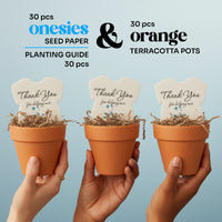 Three hands holding orange terracotta pots with plantable seed paper onesie baby shower favors, labeled as a 30-piece set with seed paper onesies, planting guide, and pots, each reading “Thank you for helping our baby bloom.”