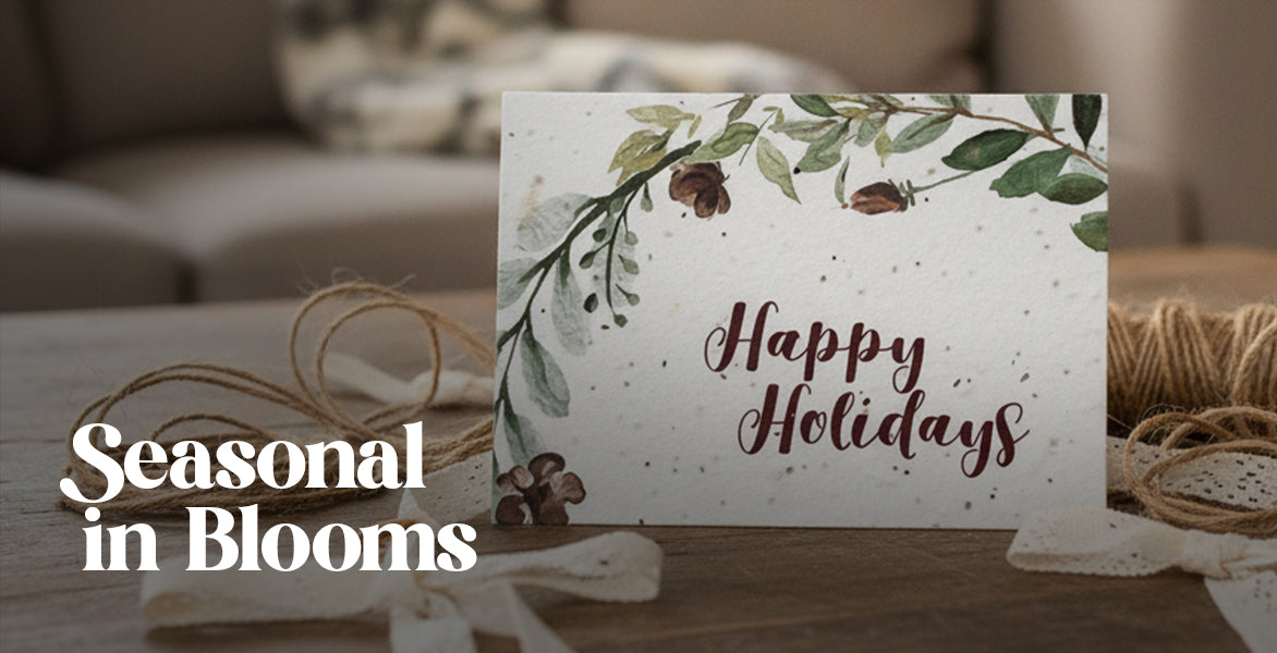 Holiday card with floral design and 'Happy Holidays' text on a wooden surface.