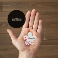 A hand holds a flower next to a size measurement, with "Bloom Thank You Tags" visible in the background