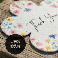 Thank you card featuring real wildflower seeds with a floral design and "Bloom Thank You Tags" text